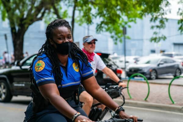 police woman riding bicycle cyclists street
